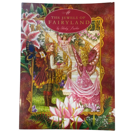 Front cover image of Shirley Barber picture book The Jewels of Fairyland . Cover shows a fairy in a pink ball gown with pink butterfly wings standing next to a male fairy wearing medieval clothes and has autumn coloured butterfly wings. They are facing a grand staircase where a small girl fairy sits and watches. All are wearing crowns. The image is framed in ornate gold decoration and surrounded by painting of different kinds of lillies.