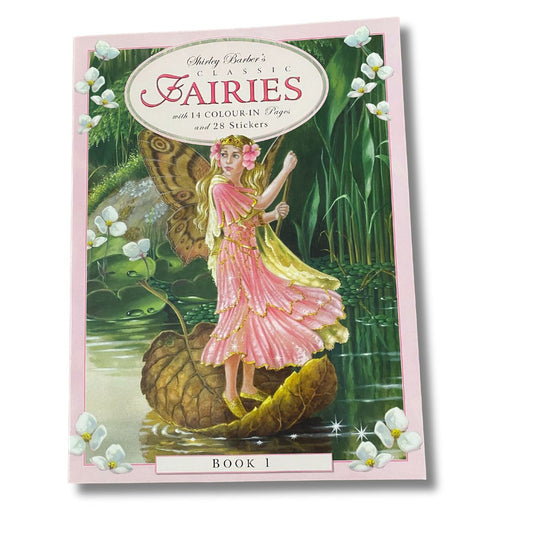 cover page of shirley barber classic fairies colour in and sticker book 1 a fairy with golden hair and a pink dress and brown butterfly wings is paddling on a lake using a leaf as a boat