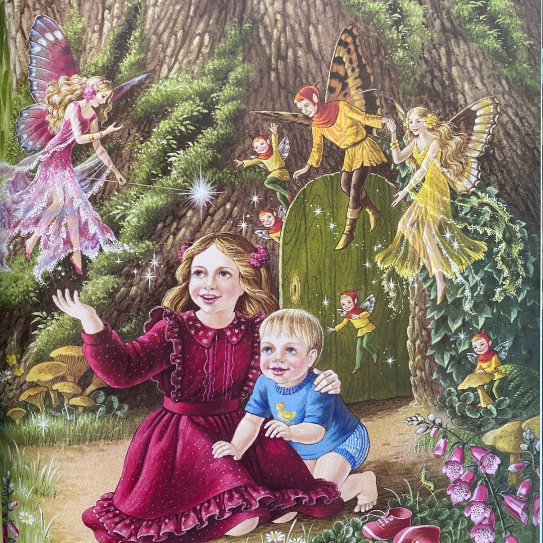 Two young children (a girl and a baby boy) sit at the foot of a tree with a door in the base of it. They are surrounded by fairies and elves in sparkling dresses and butterfly wings. 