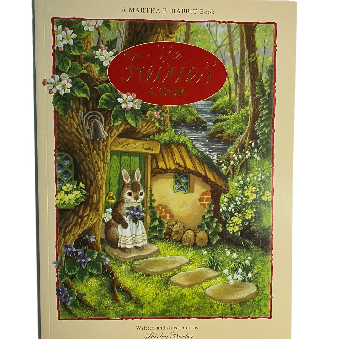 a rabbit holding flowers and dressed in an apron is standing in front of a door at the base of a tree. The door says Martha B Rabbit. This is the cover of the fairies cook by Shirley Barber