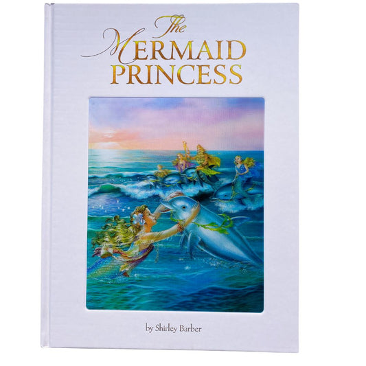 The Mermaid Princess hardcover lenticular edition cover. The cover is white with gold lettering. There is a lenticular or 3D image of a mermaid hugging a dolphin while other mermaids are riding a dolphin through the waves